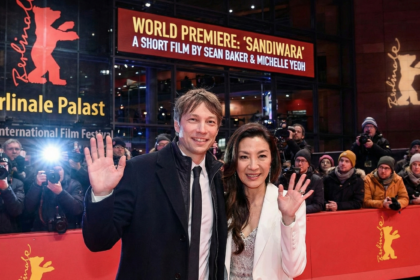 Michelle Yeoh wearing a black evening gown smiling at the 31st annual Screen Actors Guild Awards.