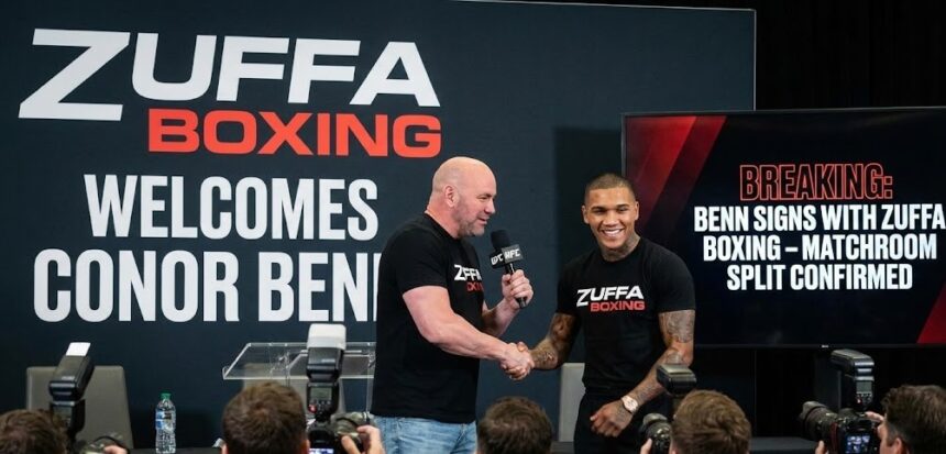 Boxer Conor Benn raising his gloves confidently inside the boxing ring.