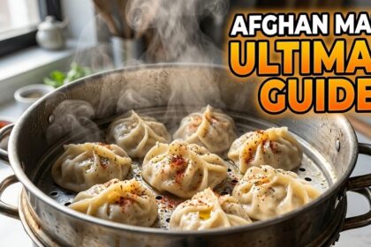 Traditional Afghan Mantu dumplings layered with yogurt and tomato-lentil sauce on a serving platter.