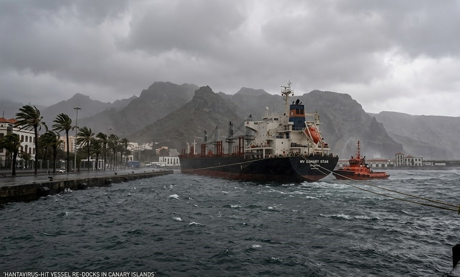 A digital graphic showing the MV Hondius moored in the Port of Granadilla under heavy winds, with medical staff in biohazard suits standing near an ambulance.