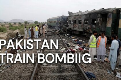Emergency rescue workers and paramilitary soldiers navigating the charred wreckage of an overturned train carriage following a massive explosion in Quetta, Pakistan.