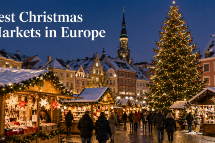 A beautifully lit wooden chalet selling traditional ornaments at a snowy European Christmas market at night.